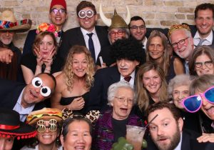 People having fun with props in a photo booth at a Chicago Wedding